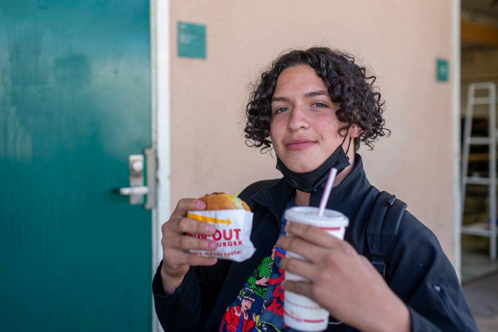 NMSS student holds up a burger and soda.