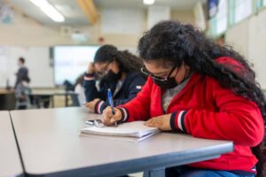 New Millennium Charter School student in red sweater studying